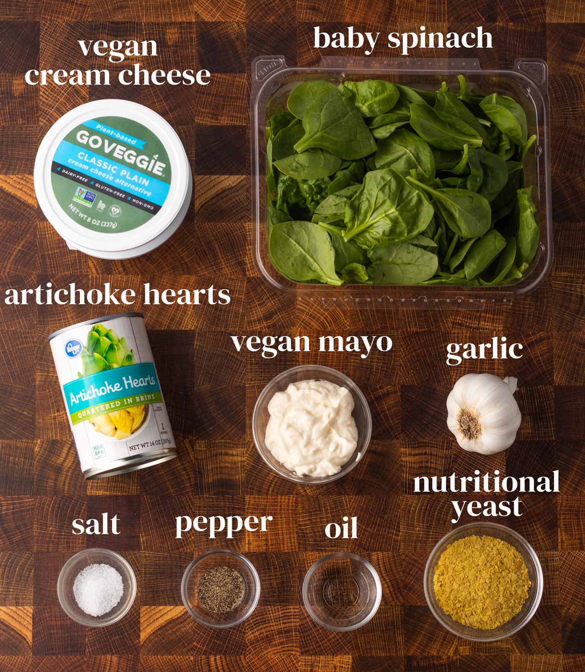 Ingredients laid out on a surface (dairy-free cream cheese, spinach, artichoke hearts, mayo, garlic, and seasonings.)